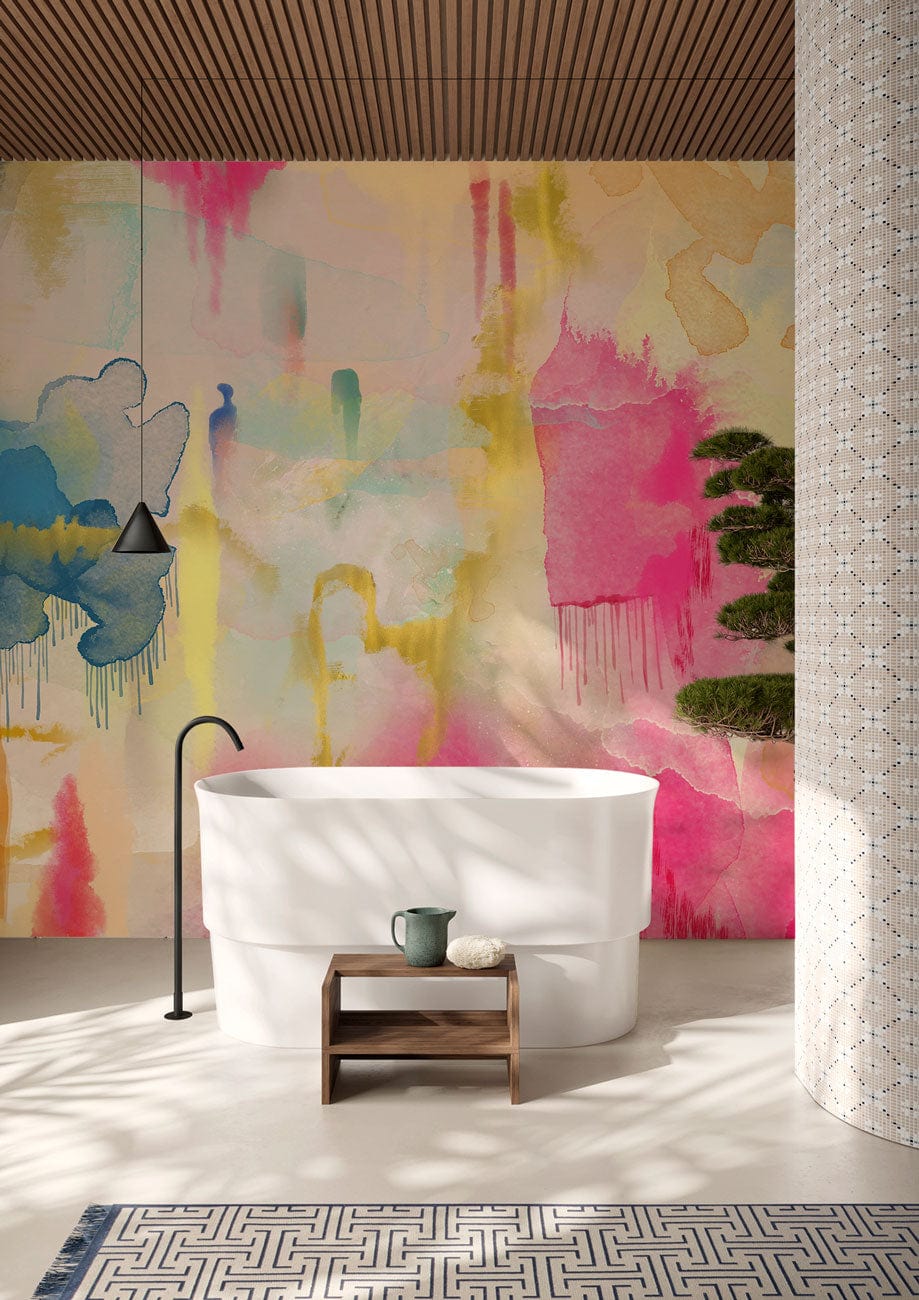 Vibrant watercolour abstract mural wallpaper in modern bathroom setting with freestanding tub and geometric rug.