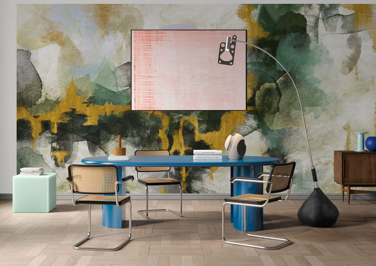 Abstract watercolour mural wallpaper with earthy greens, golden hues; modern dining room with blue table.