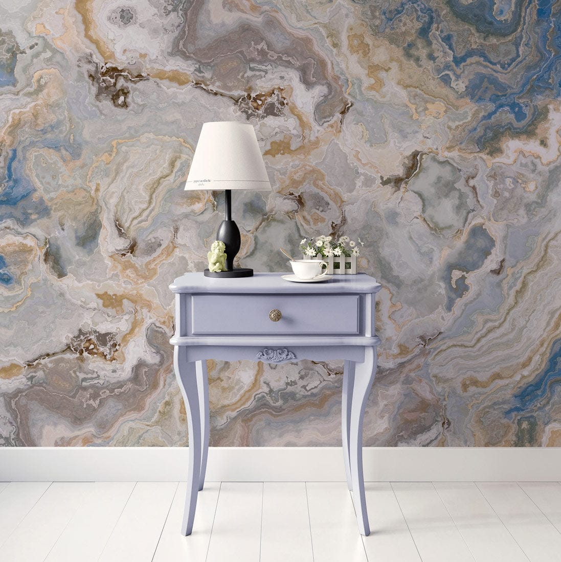 Elegant blue marble abstract mural wallpaper, vintage lamp on light purple side table, white flooring.