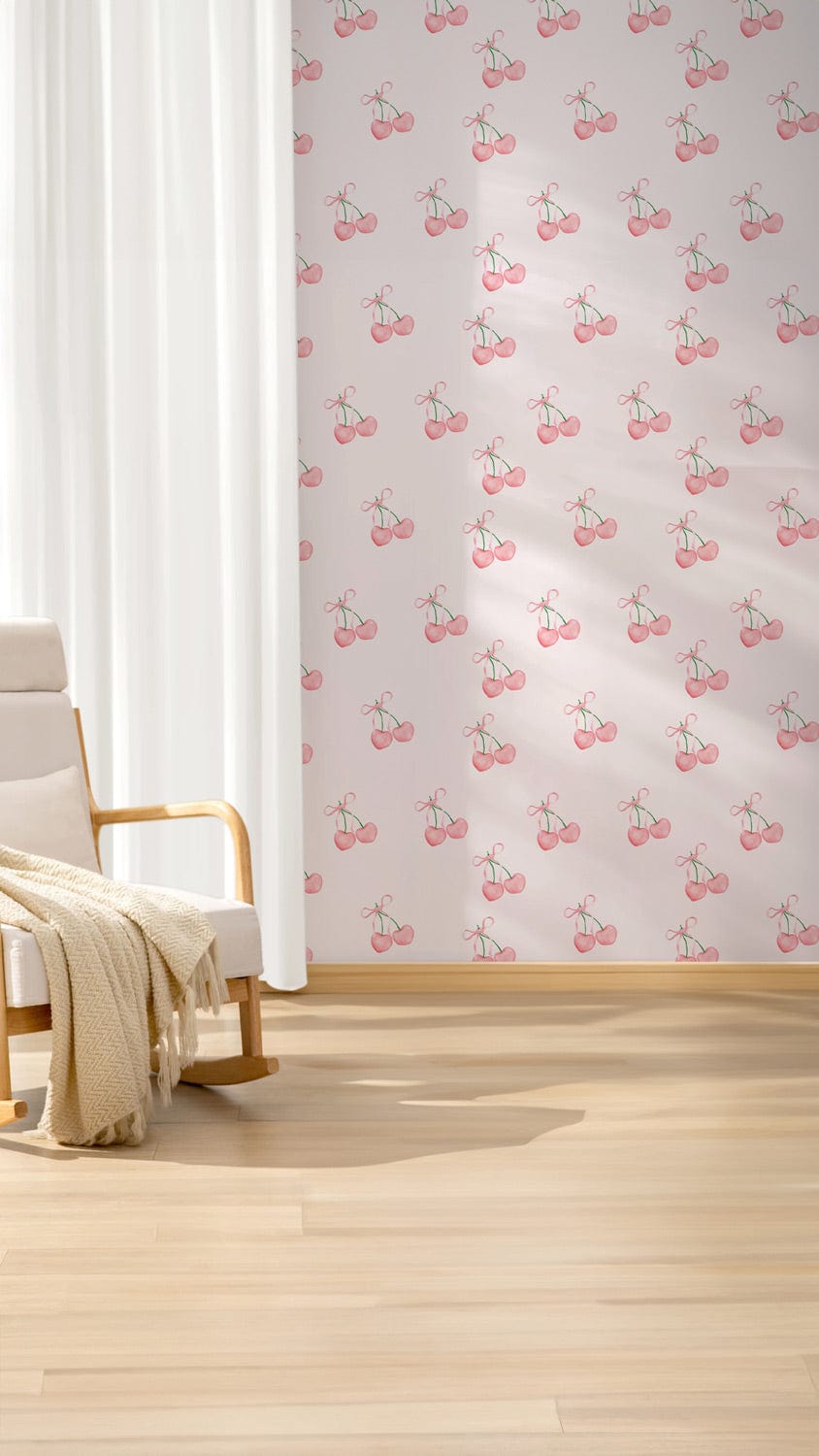 Vintage pink cherry wallpaper in a living room with light wooden flooring and a modern armchair.