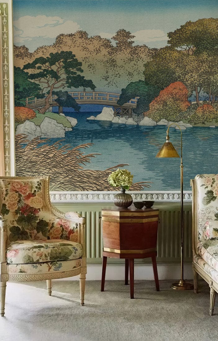 Elegant living room with Japanese mural wallpaper, floral armchairs, wooden side table, and floor lamp.