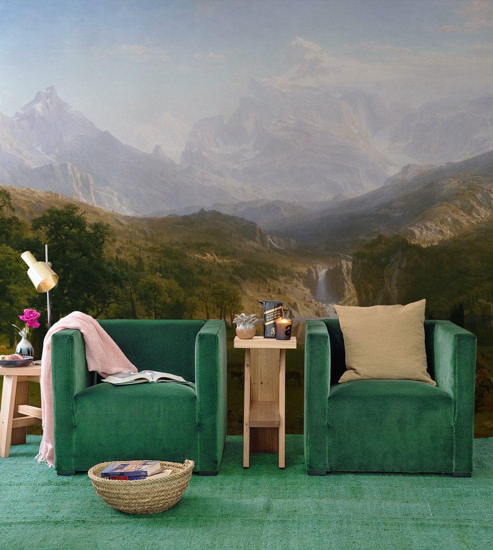 Majestic Mountain Vista mural with green armchairs, wooden side table, and green rug in living room.