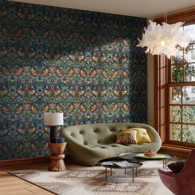 Luxurious living room with Floral Birds Victorian multicolour wallpaper, green sofa, ornate chandelier, wooden flooring.