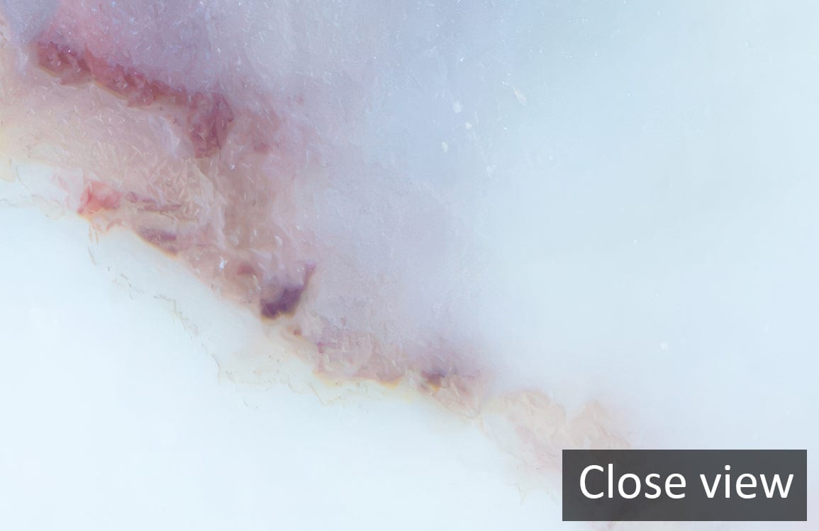 Close-up of abstract watercolour marble effect wallpaper in blue and earthy tones.