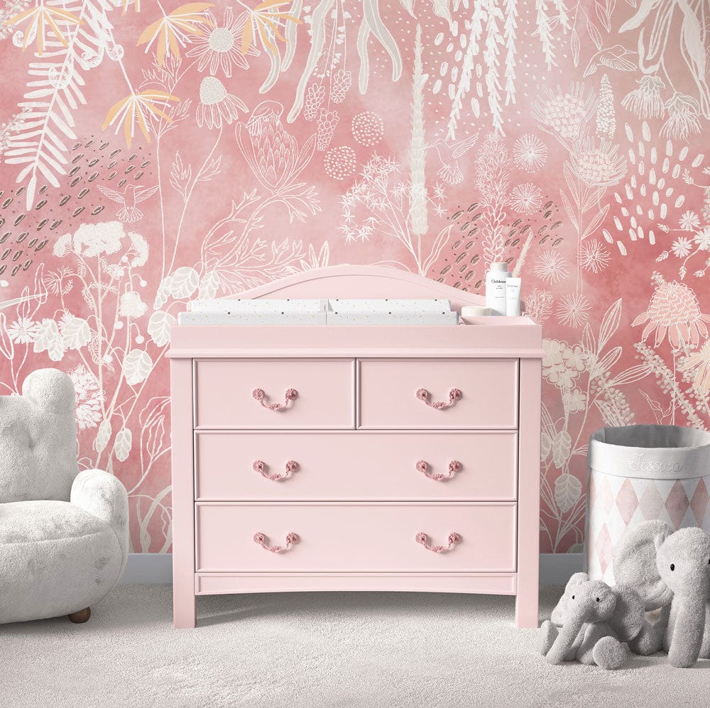 Rustic Blush Botanical Mural Wallpaper, pink dresser, grey plush chair in nursery with floral motif.