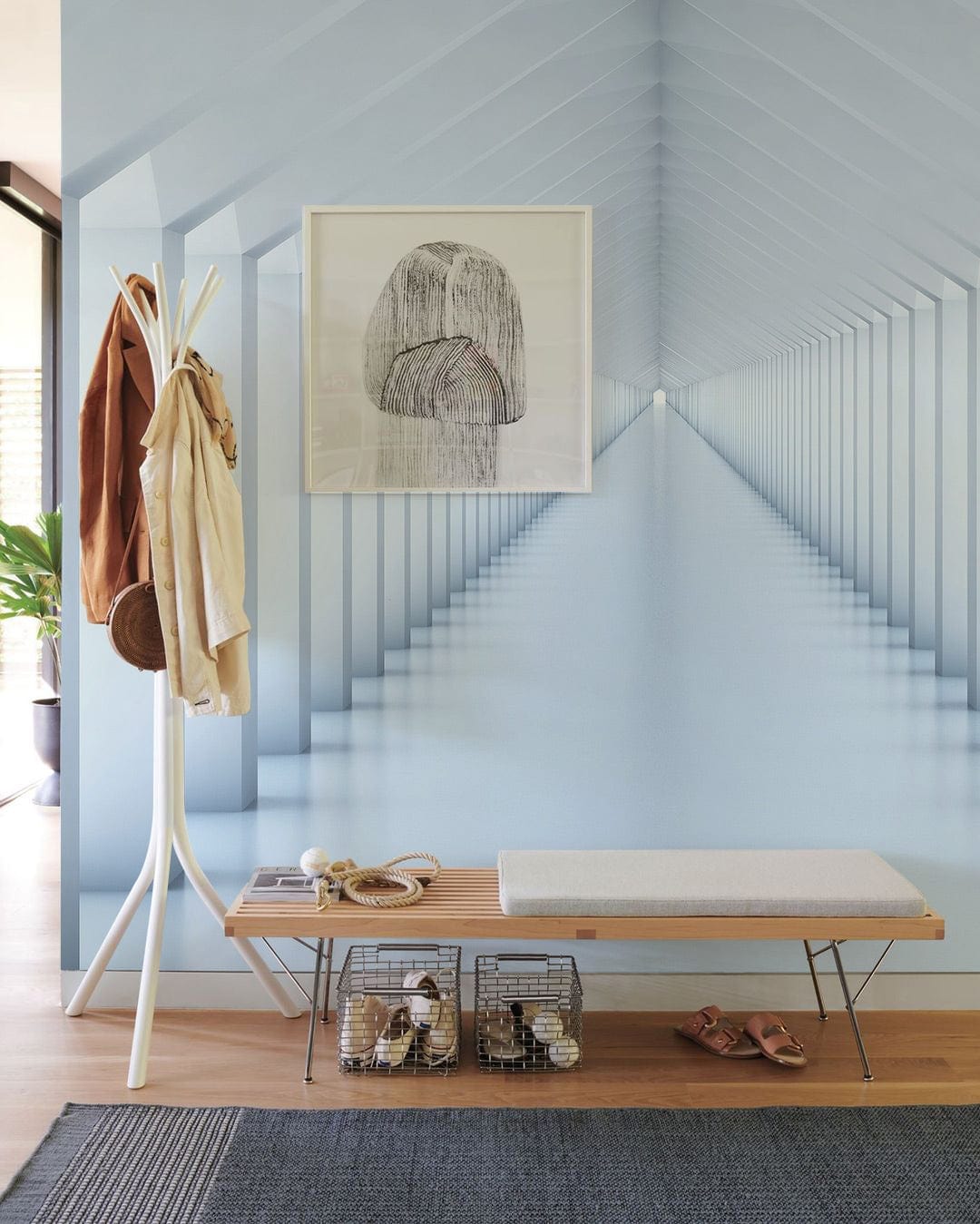 Modern minimalist white geometric tunnel mural wallpaper, light wood bench, blue feature wall, hallway.