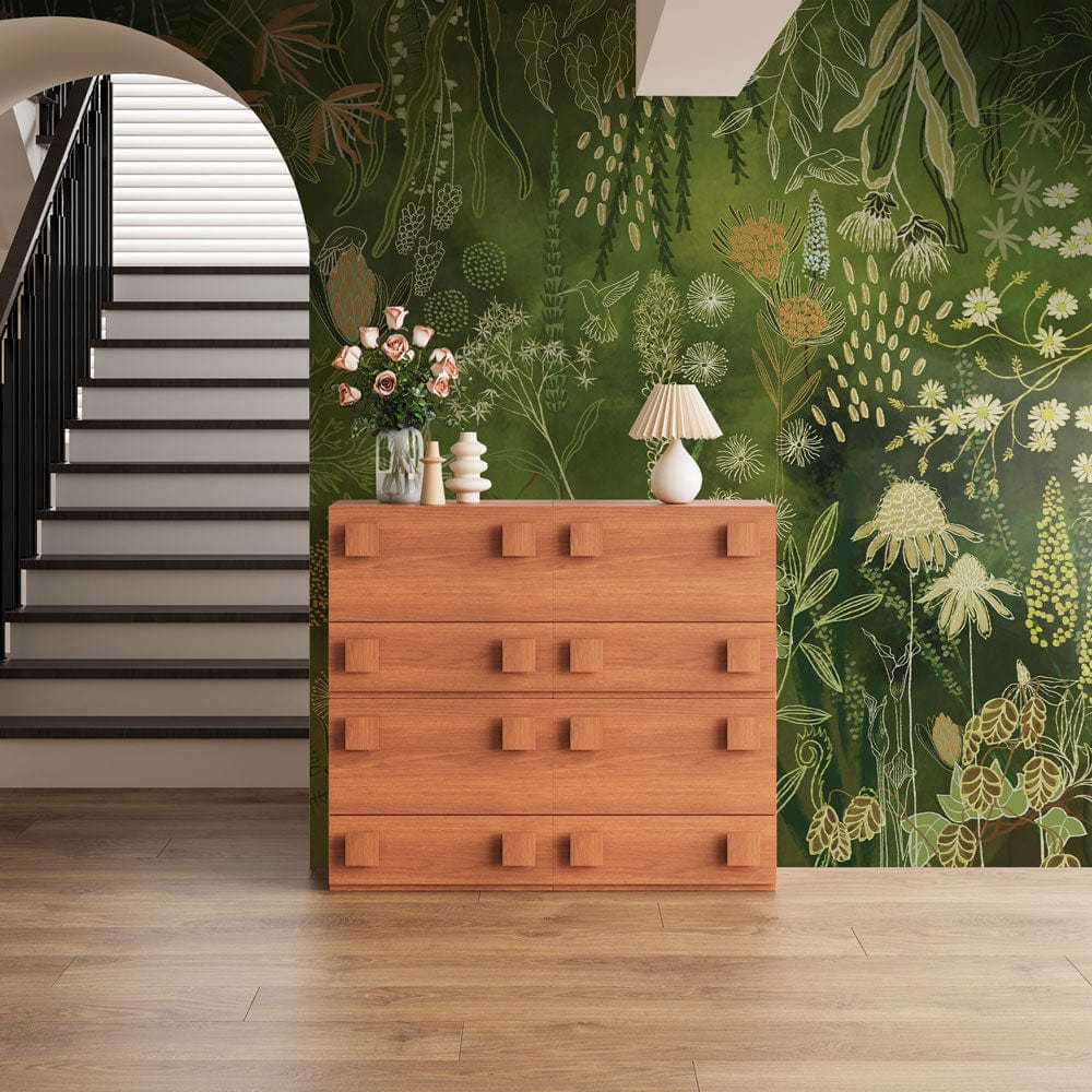 Luxurious green botanical mural wallpaper in elegant interior with wooden dresser, staircase, wood flooring.