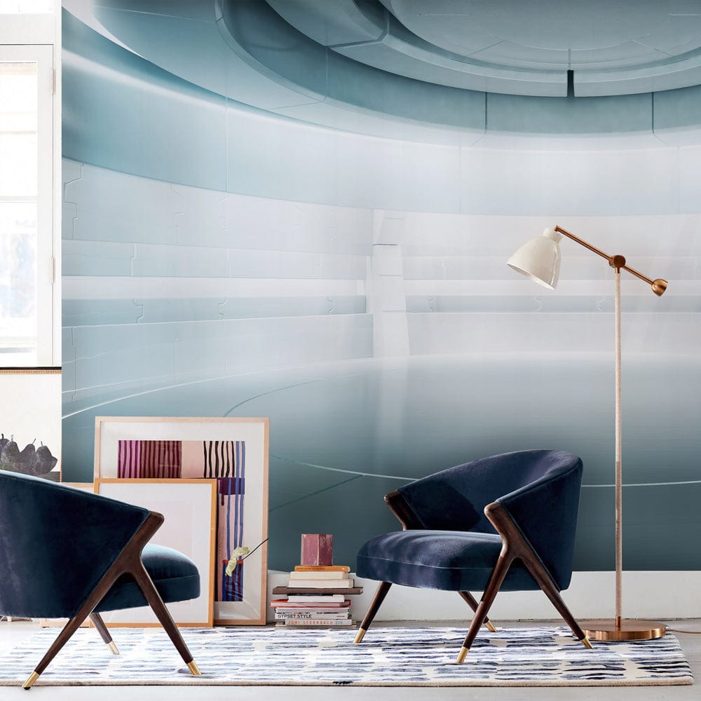 Futuristic metallic silver sci-fi mural wallpaper, featuring modern blue armchairs, geometric rug, floor lamp.