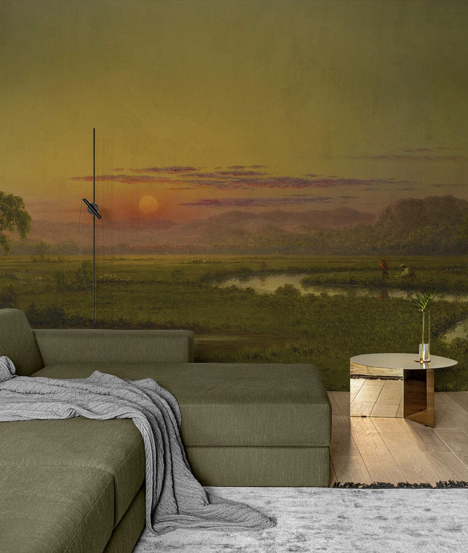 Sunset Serenity Landscape Mural Wallpaper, lush green sofa, modern living room, wooden flooring, gold table.