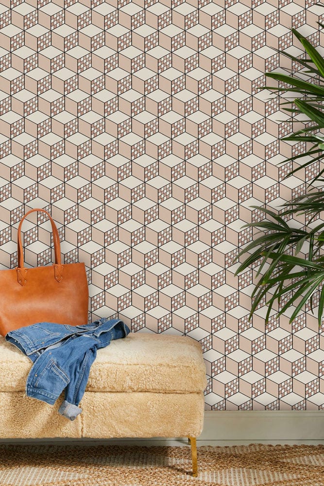 Geometric taupe and white 3D cube wallpaper design in living room with plush beige bench seating.