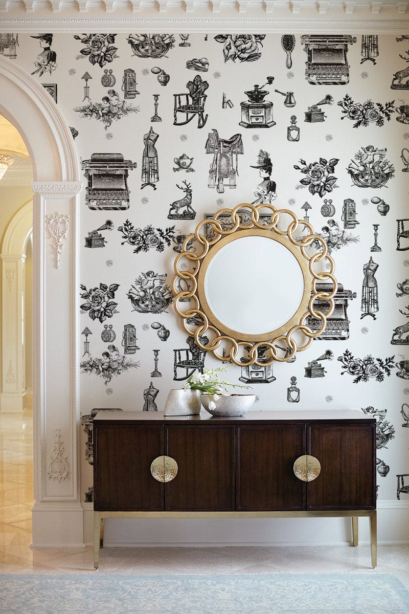 Vintage monochrome toile wallpaper with antique black design, ornate mirror, dark wood sideboard in hallway.
