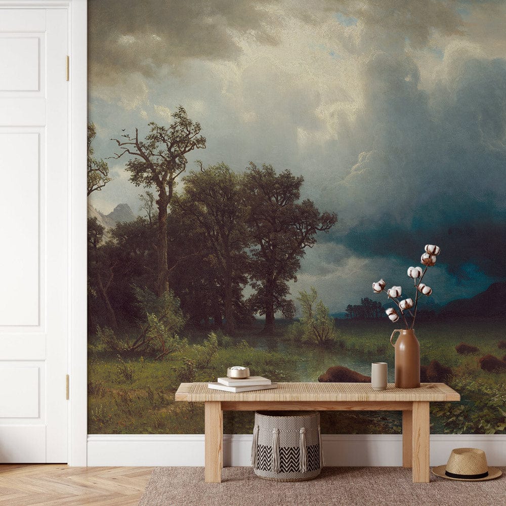 Majestic Wilderness Landscape Mural Wallpaper; rich green and blue tones; rustic bench; neutral rug.