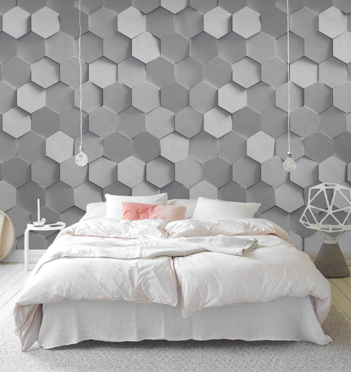 Modern grey hexagonal pattern wallpaper in bedroom with white bedding, geometric decor, light wood flooring.