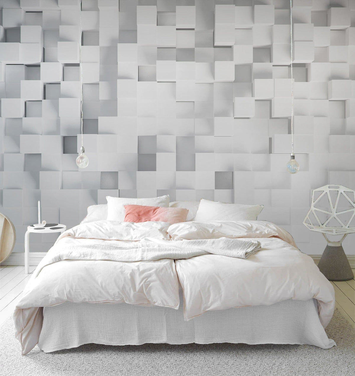 Modern white geometric 3D wall mural behind cosy bed in minimalist bedroom with white flooring.