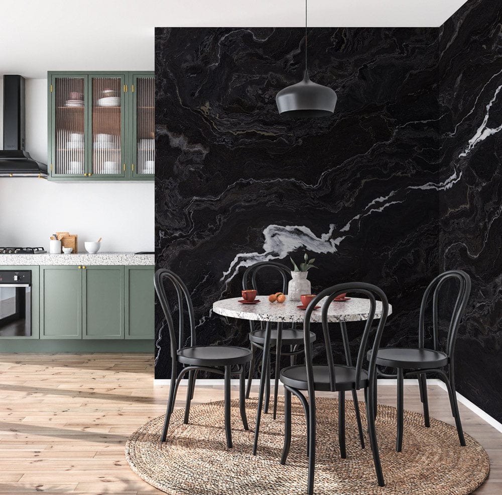 Elegant black marble effect wallpaper, dramatic veins; dining room with round table, modern chairs, pendant light.