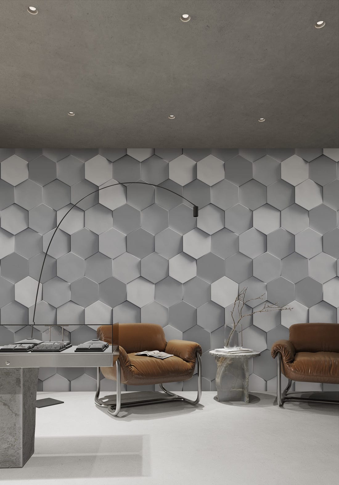 Modern grey hexagonal wallpaper in contemporary room with brown armchairs, concrete flooring, and arc lamp.