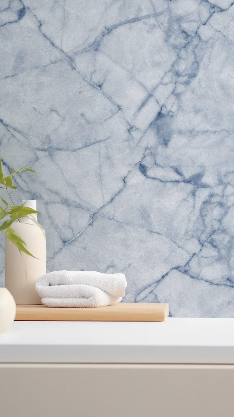 Elegant blue marble wallpaper in modern room, featuring white towels and minimalist countertop decor.