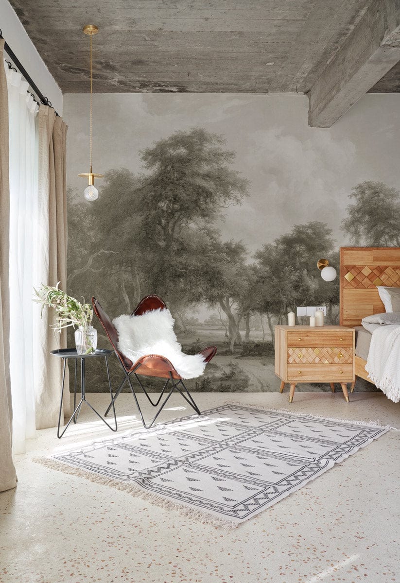 Rustic Sepia Woodland Landscape Wallpaper in modern bedroom with wooden bed, patterned rug, and armchair.
