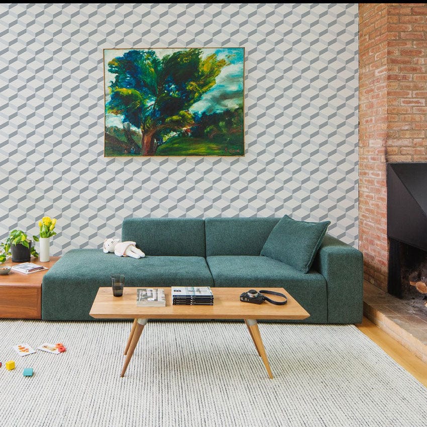 Modern Geometric Grey and White Patterned Wallpaper, green sofa, wooden coffee table, living room decor.