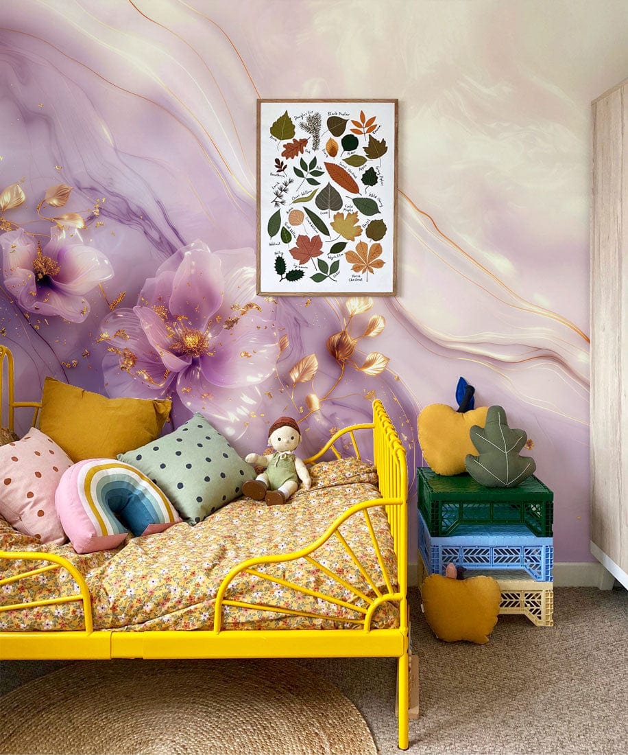 Yellow bed against lavender floral mural wallpaper with gold accents in cosy bedroom; decorative pillows.