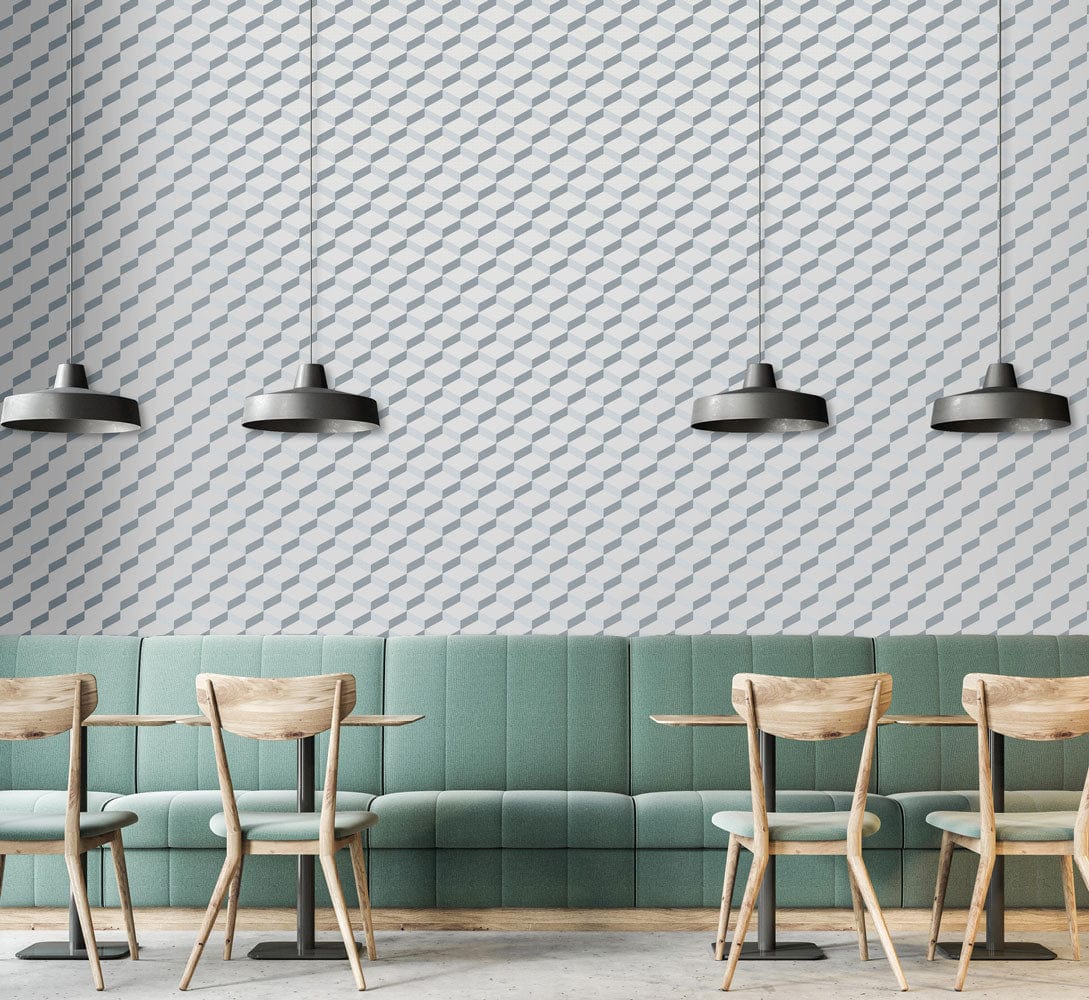 Modern geometric grey and white wallpaper in dining room, green bench seating, wooden chairs, pendant lights.