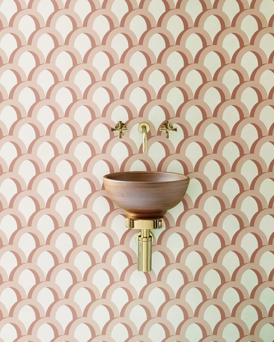 Elegant peach scales wallpaper with modern minimalist design, featuring brass sink and wall-mounted taps.