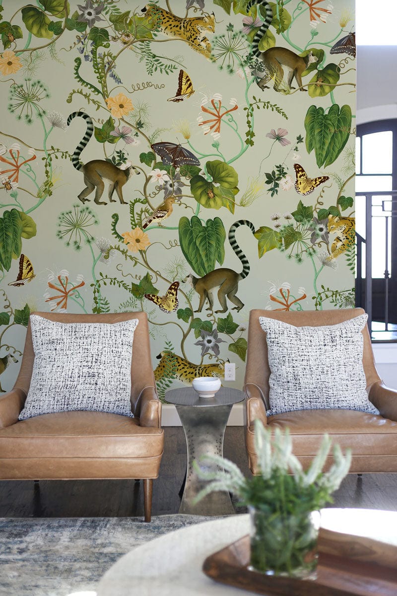 Tropical Safari Wildlife Mural with lush jungle, leather chairs, grey rug, in a modern living room.