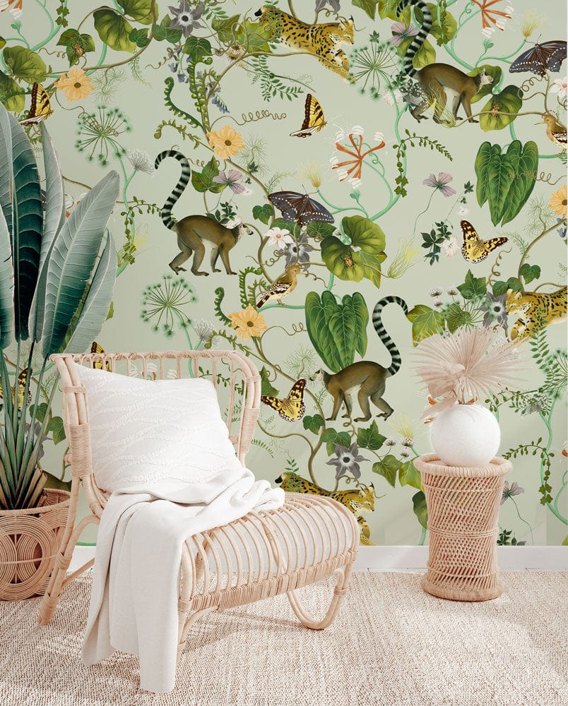 Tropical Safari Wallpaper, green jungle print, wicker chair, neutral rug, safari-themed living room decor.
