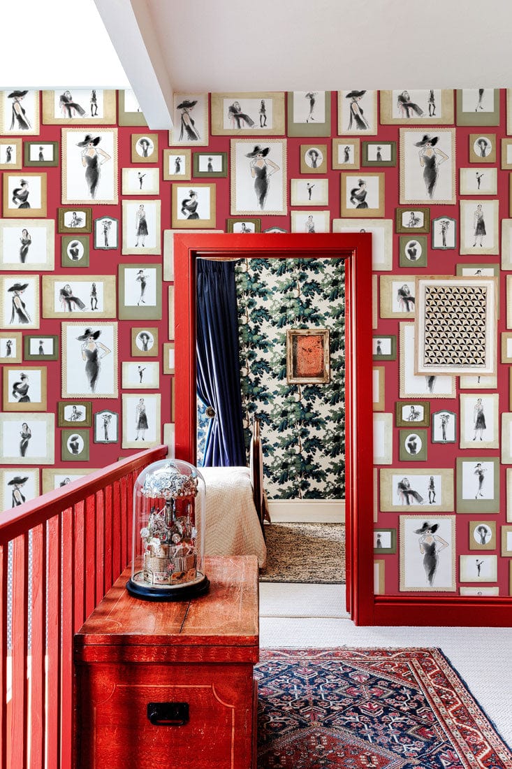 Vintage red-toned artwork wallpaper, eclectic room, red accents, classic staircase, oriental rug, artistic interiors.