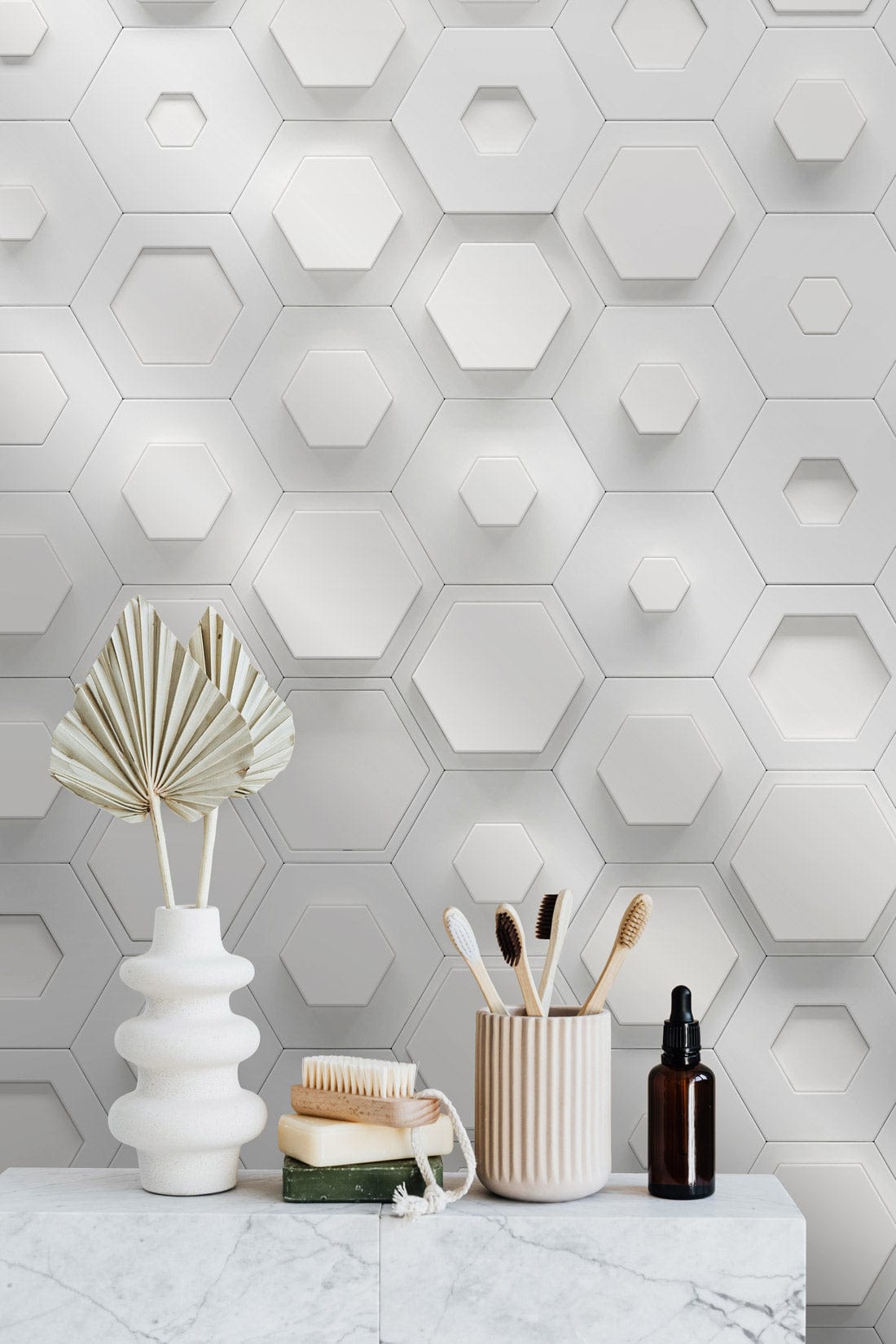 White hexagonal 3D wallpaper, modern geometric wall decor, marble countertop, decorative vases, neutral tones.