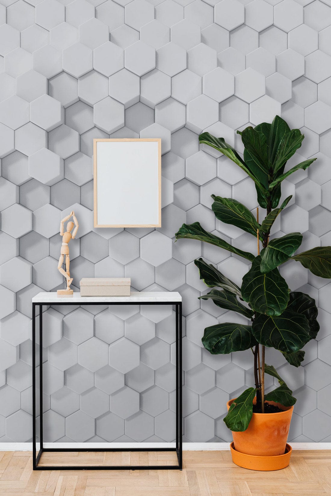 Geometric hexagonal 3D wallpaper, modern minimalist design; white console table, wooden floor, large plant.