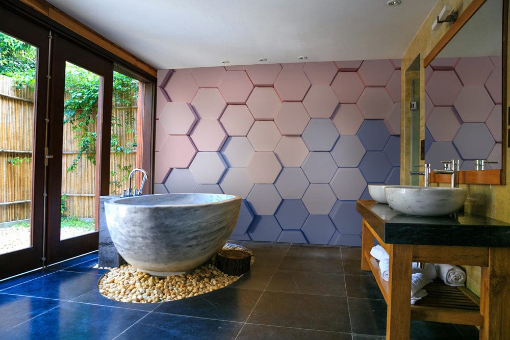 Bathroom with pastel geometric hexagon wallpaper, stone bathtub, wooden vanity, slate flooring, and large window.