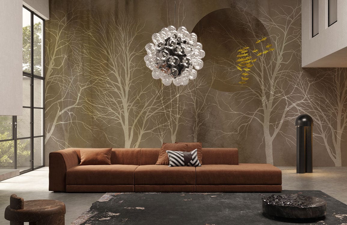 Elegant forest mural wallpaper, earthy tones in living room, featuring brown sofa, modern lighting fixture.