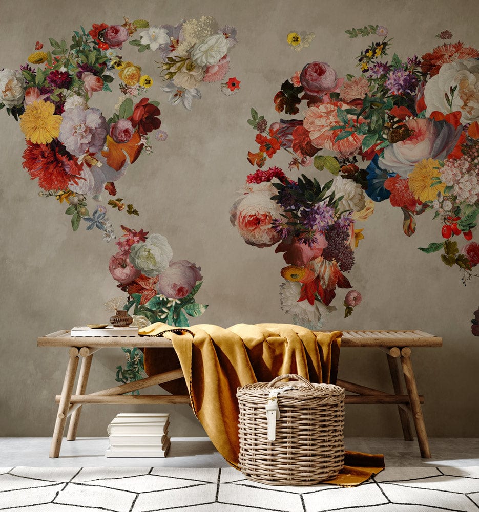 Elegant Floral World Map Mural Wallpaper in vintage tones, on beige wall, with wooden bench.
