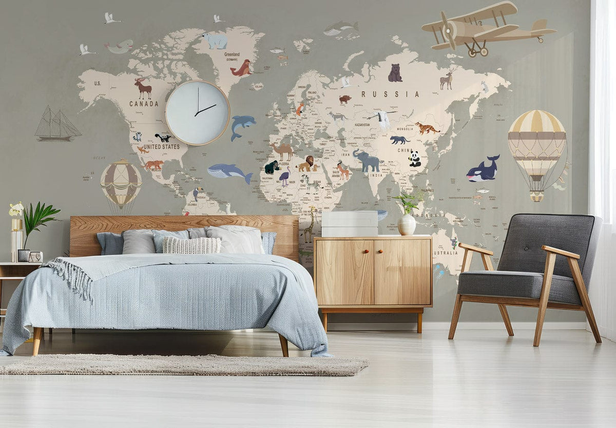 Vintage World Map mural wallpaper with animals, neutral bedroom setting, grey armchair, wooden furniture.