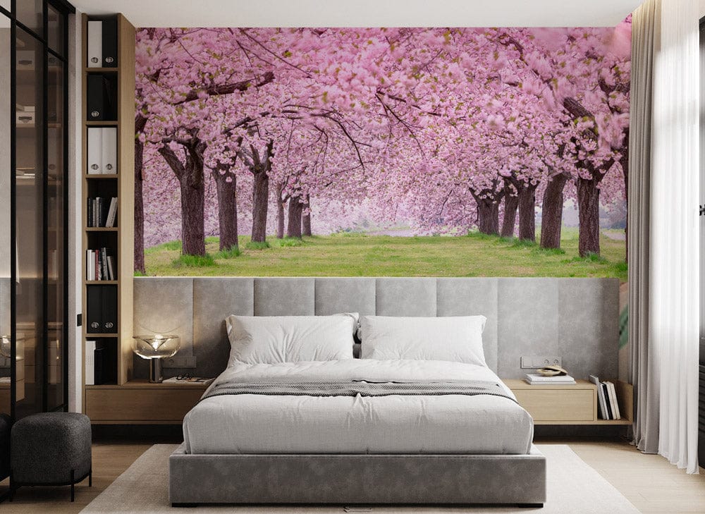 Serene Pink Blossom Garden Mural in bedroom with grey bed, wooden flooring, and modern decor.
