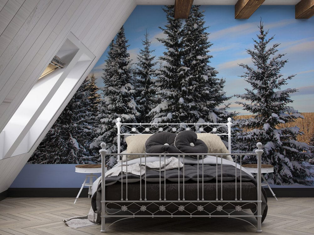 Snowy pine forest wall mural in bedroom with metal bed, wood beams, and blue wall.