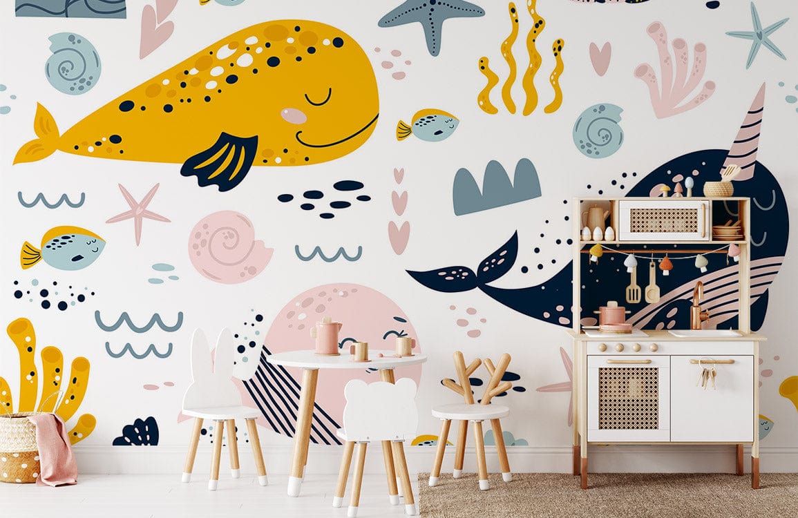 Underwater Adventure Whales and Narwhals Kids' Mural Wallpaper with playroom furniture and white walls.