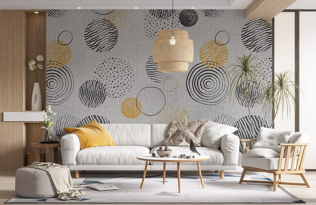 Monochrome and gold geometric wallpaper in modern living room with white sofa, wooden coffee table, and decor.