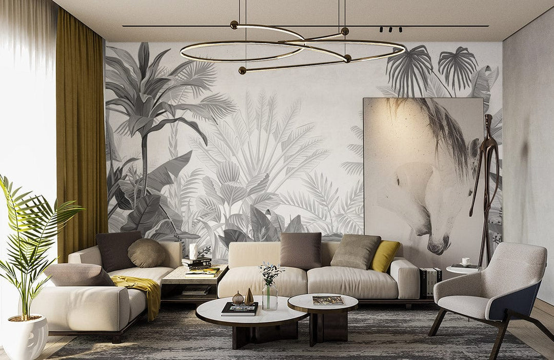 Monochrome tropical jungle wallpaper in stylish lounge with beige sofa, abstract painting, and modern chandelier.