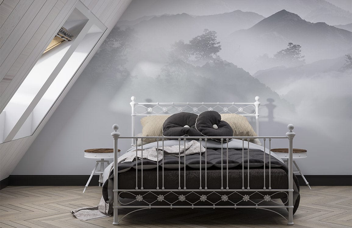 Ethereal Misty Mountain wallpaper behind white bed, attic room with chevron flooring, calming grey tones.