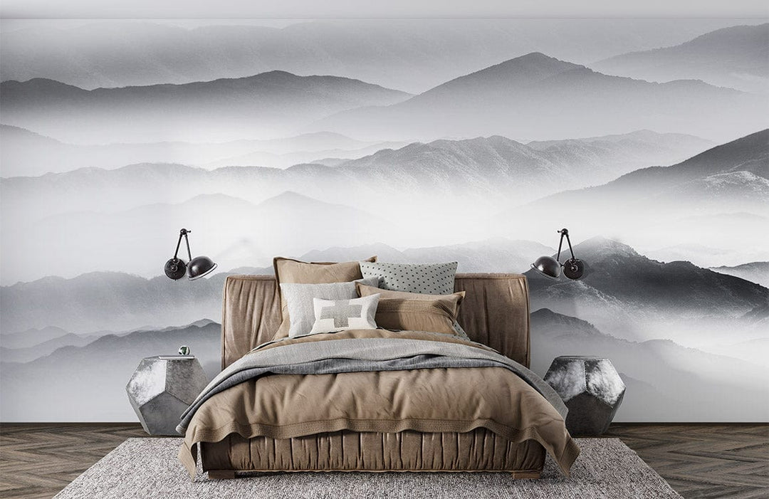 Serene Misty Mountain mural wallpaper, grey tones, modern bedroom, brown bed, wooden flooring, wall lamps.