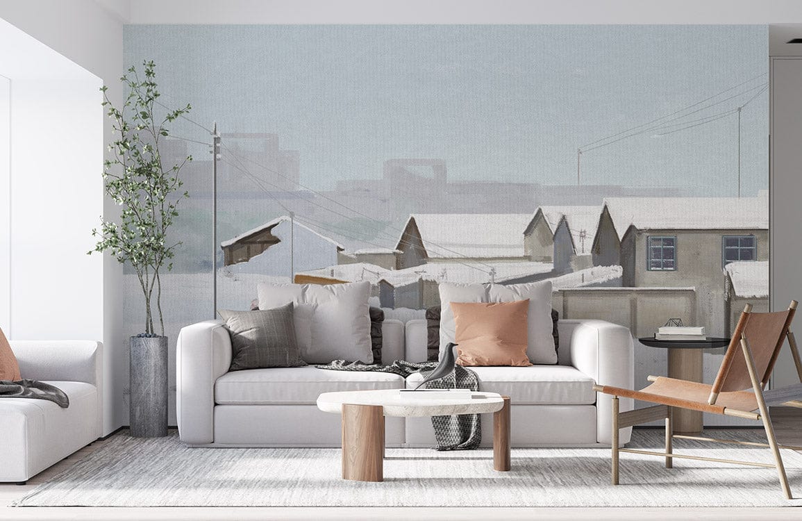 Winter Village Scene Mural Wallpaper in living room with white sofa, grey rug, wood table, and chair.