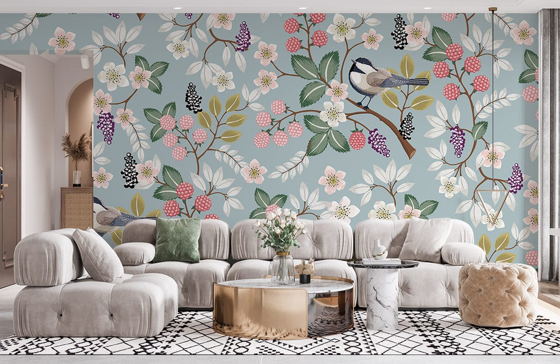 Floral vintage bird wallpaper in living room, pastel berries on blue. Neutral sofa, geometric rug.