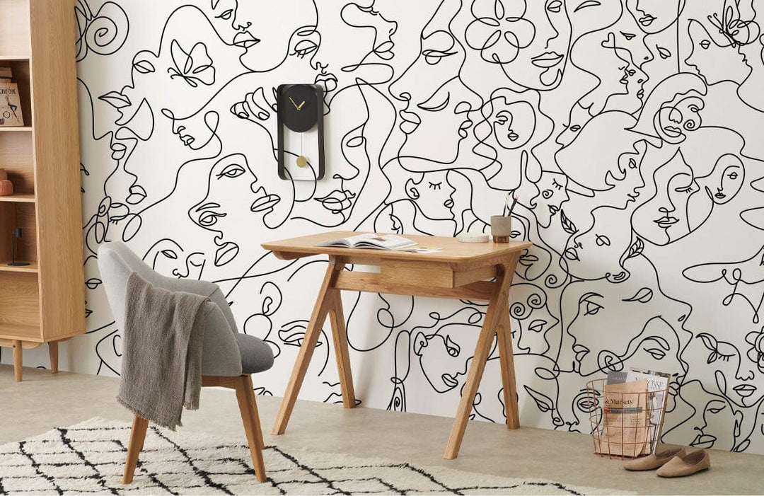 Monochrome line art wall mural with wooden desk, grey chair, contemporary rug in modern interior.