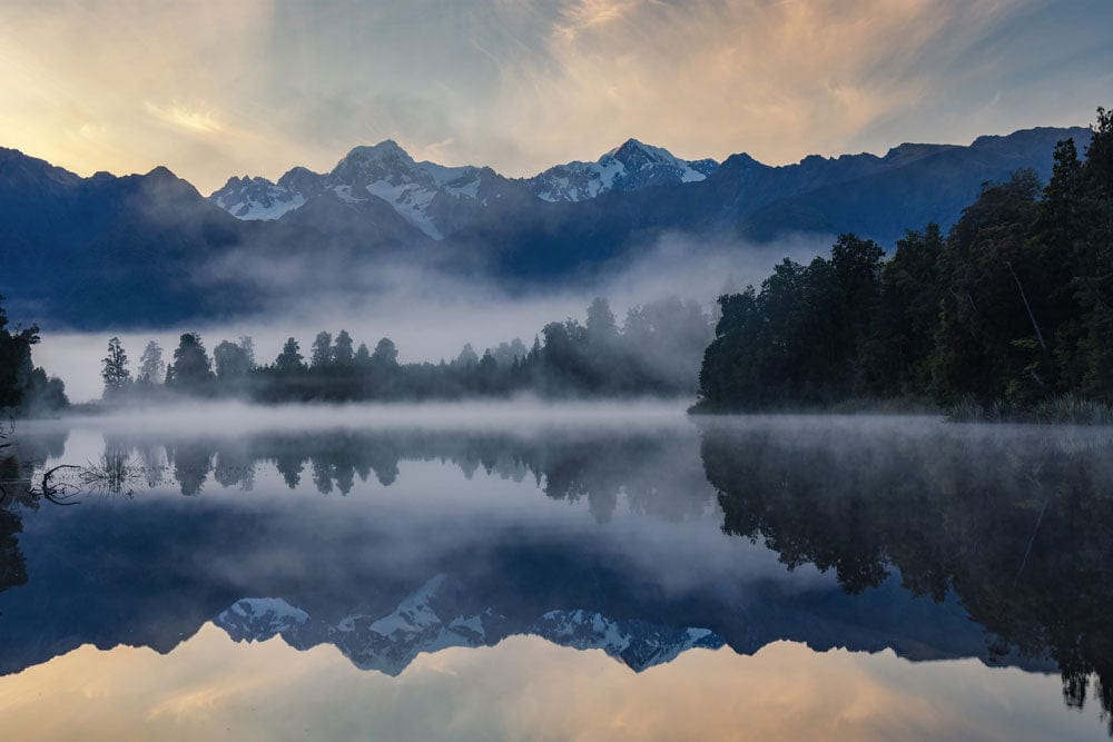 Serene Mountain Lake Reflection Mural Wallpaper in Misty Blue Hue