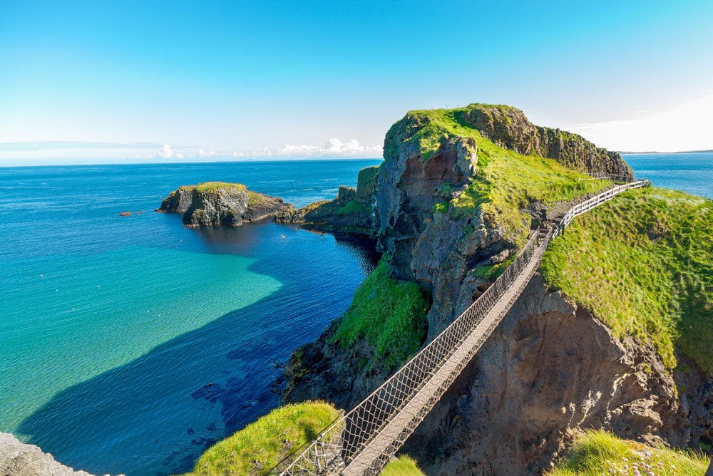 Tranquil Coastal Cliff Mural Wallpaper in Vibrant Green and Blue Scenic Design