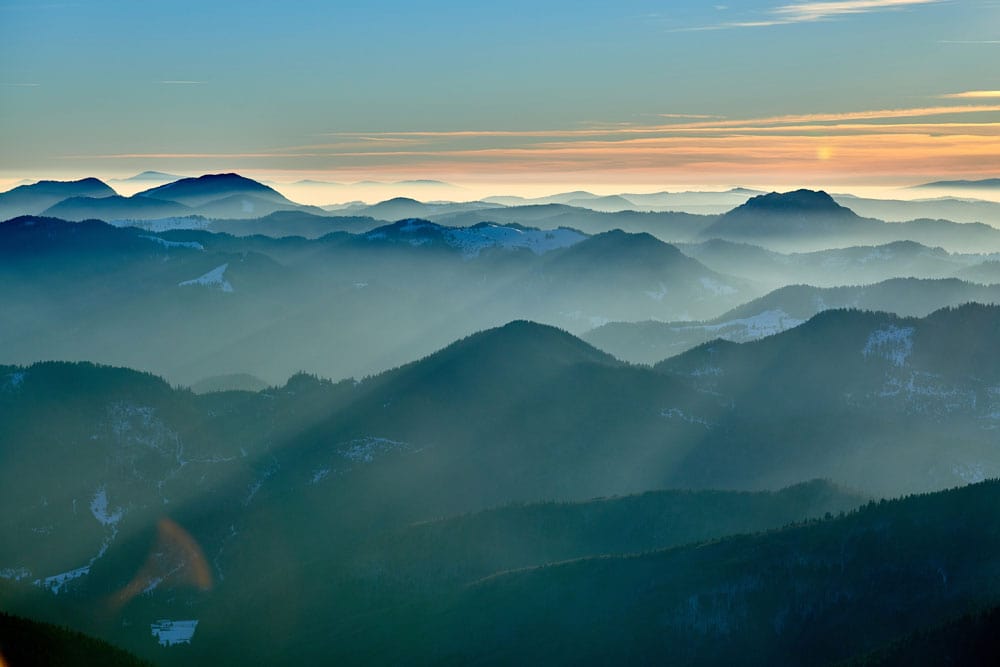 Serene Mountain Ridge Mist Scenic Sunset Mural Wallpaper in Blue and Green