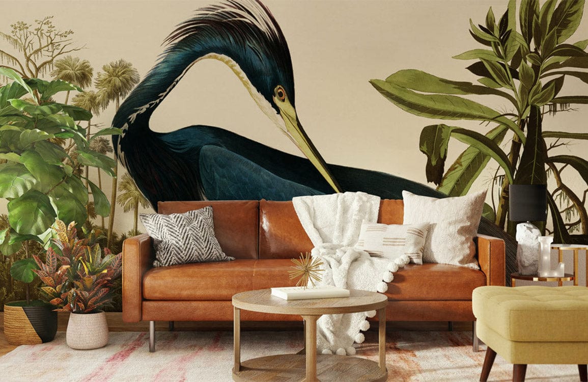 Elegant Blue Heron Mural Wallpaper in living room with brown sofa, tropical decor, and wooden flooring.
