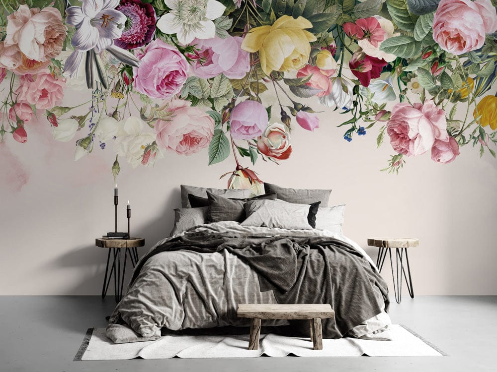 Vintage floral mural wallpaper in pastel with grey bed, wooden benches, and side tables in bedroom.